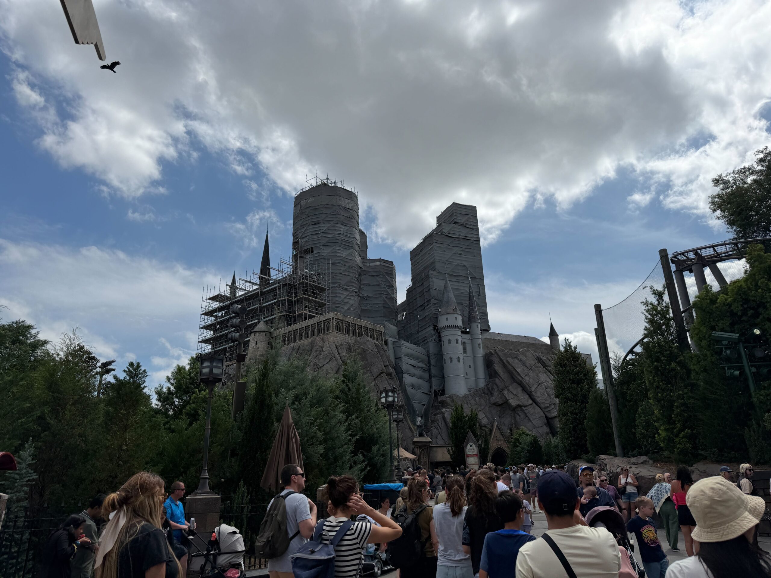 Workers on scaffolding performing restoration work on castle exterior