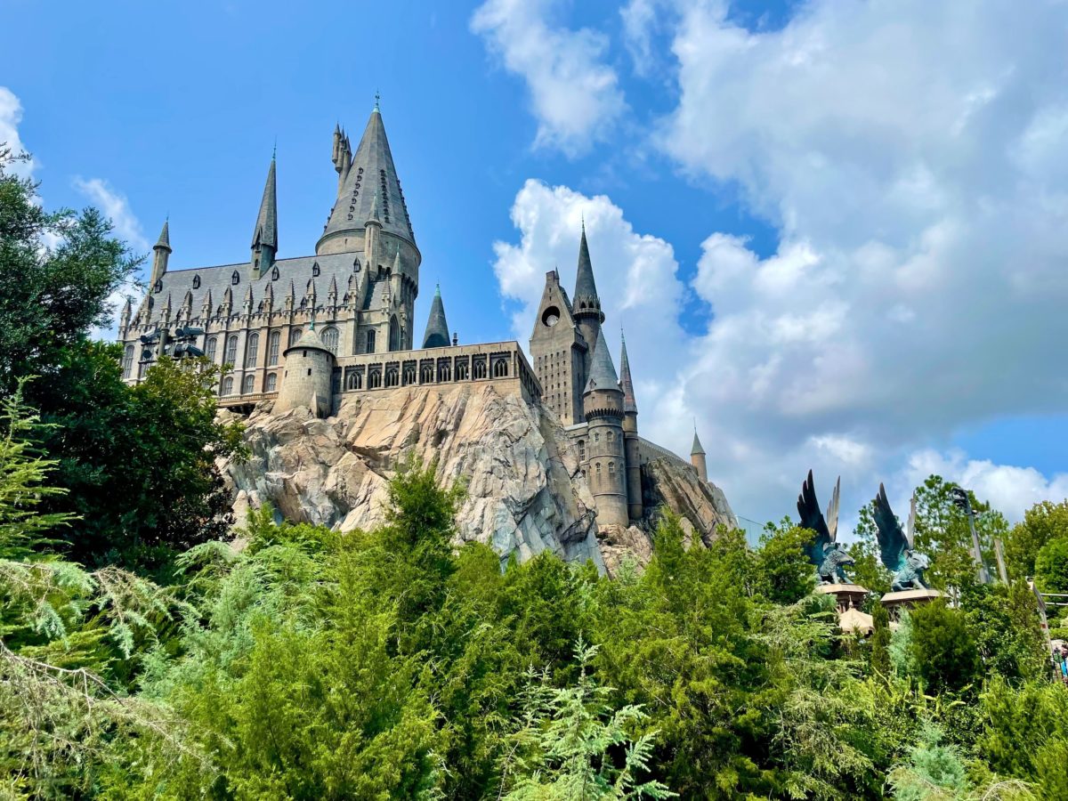 Wide view of Hogwarts Castle showing multiple towers in different stages of refurbishment